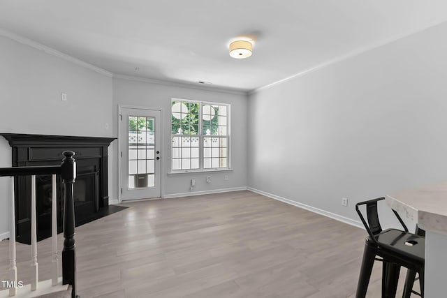 4536 Sugarbend Way, Raleigh, NC 27606 - unfurnished living room with ornamental molding, wood finished floors, and a fireplace with flush hearth