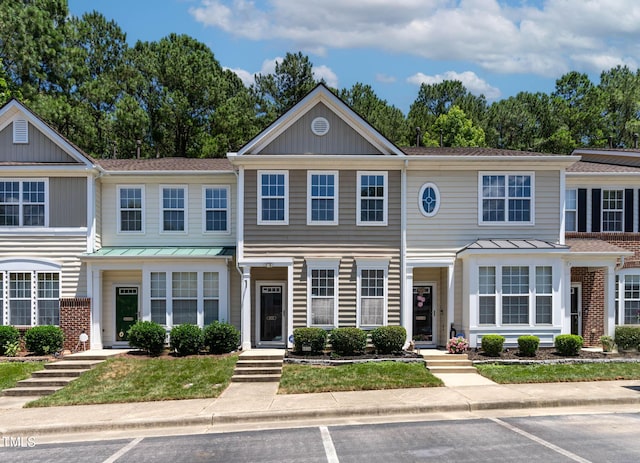 4536 Sugarbend Way, Raleigh, NC 27606 - townhome / multi-family property featuring a standing seam roof, uncovered parking, and a metal roof