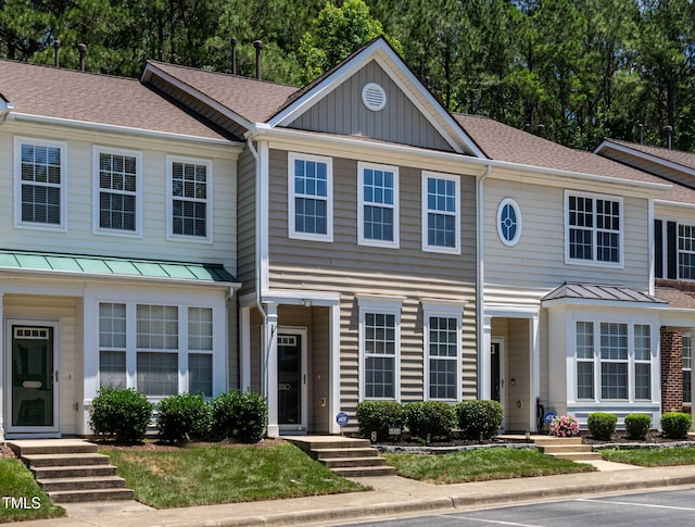 4536 Sugarbend Way, Raleigh, NC 27606 - view of property with a standing seam roof, a shingled roof, board and batten siding, and a metal roof