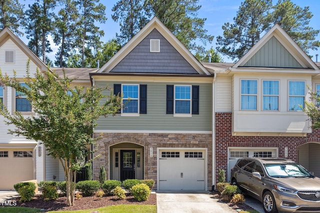3810 Prince Noah Loop, Wake Forest, NC 27587 - view of front of home featuring an attached garage, concrete driveway, board and batten siding, and stone siding