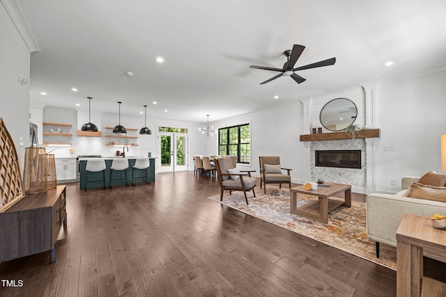 1317 Fay St, Durham, NC 27701 - living area with a ceiling fan, a fireplace, recessed lighting, dark wood-type flooring, and crown molding
