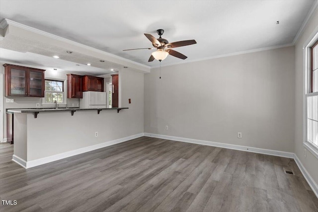 136 Dixie Ln, Youngsville, NC 27596 - unfurnished living room with ceiling fan, wood finished floors, crown molding, and recessed lighting