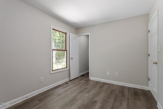 136 Dixie Ln, Youngsville, NC 27596 - unfurnished bedroom with wood finished floors and baseboards