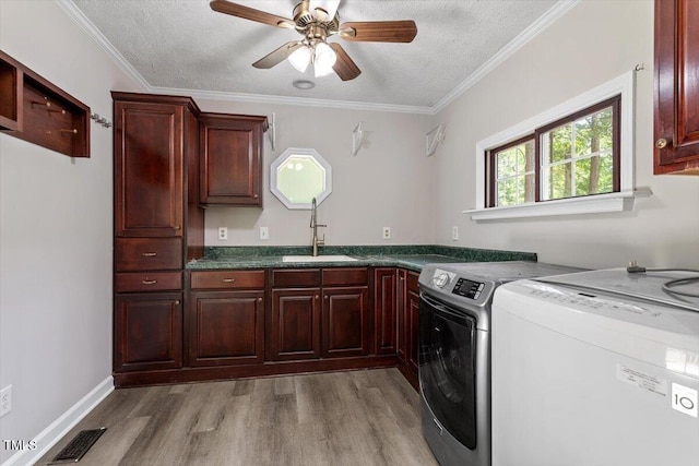 136 Dixie Ln, Youngsville, NC 27596 - washroom with cabinet space, a textured ceiling, washing machine and dryer, light wood-style flooring, and ceiling fan