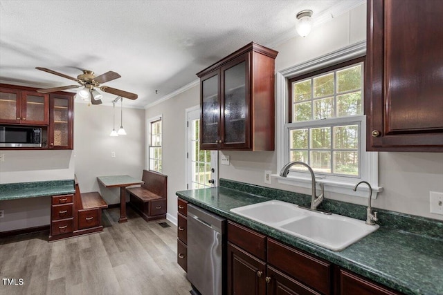 136 Dixie Ln, Youngsville, NC 27596 - kitchen with stainless steel appliances, ornamental molding, dark countertops, light wood-style floors, and healthy amount of natural light