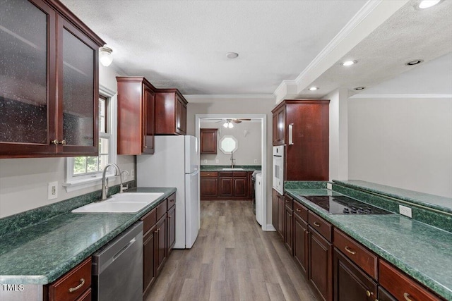 136 Dixie Ln, Youngsville, NC 27596 - kitchen featuring white appliances, light wood-style flooring, crown molding, dark countertops, and a ceiling fan