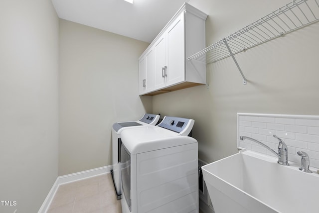 610 Chronicle Dr, Cary, NC 27513 - washroom featuring washer and dryer, cabinet space, and light tile patterned floors