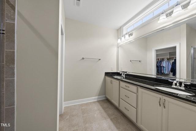 610 Chronicle Dr, Cary, NC 27513 - full bathroom with double vanity, a walk in closet, and tile patterned floors