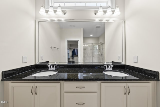 610 Chronicle Dr, Cary, NC 27513 - bathroom featuring double vanity, a stall shower, healthy amount of natural light, and a walk in closet