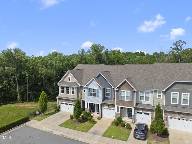 610 Chronicle Dr, Cary, NC 27513 - multi unit property featuring concrete driveway, stone siding, an attached garage, and a front lawn