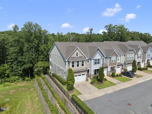 610 Chronicle Dr, Cary, NC 27513 - view of front facade with an attached garage, concrete driveway, and stone siding