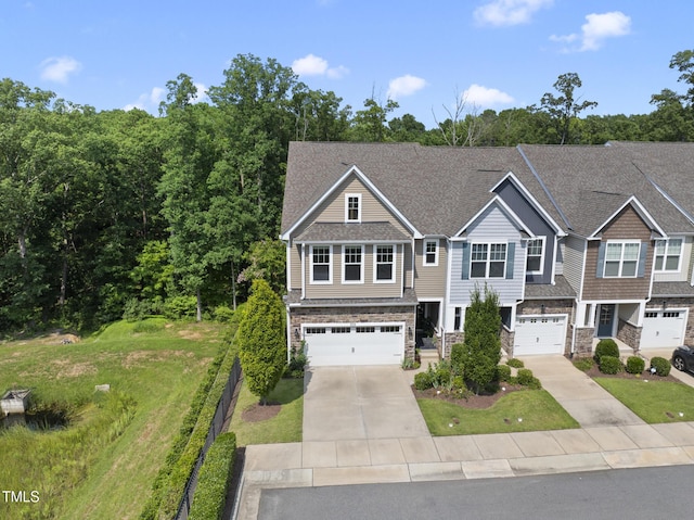 610 Chronicle Dr, Cary, NC 27513 - view of front of property with concrete driveway, a garage, stone siding, and a front lawn