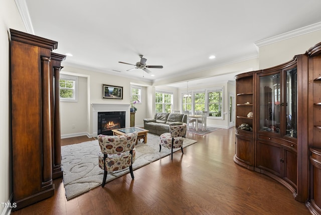 610 Chronicle Dr, Cary, NC 27513 - living room with ceiling fan, dark wood-style floors, recessed lighting, ornamental molding, and a glass covered fireplace