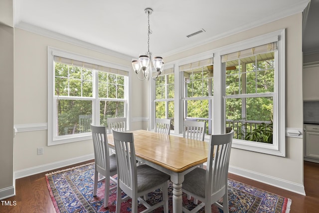 610 Chronicle Dr, Cary, NC 27513 - dining room with a chandelier, plenty of natural light, ornamental molding, and dark wood-style flooring