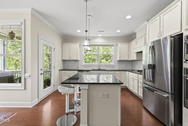 610 Chronicle Dr, Cary, NC 27513 - kitchen featuring stainless steel appliances, decorative backsplash, a kitchen island, white cabinets, and recessed lighting