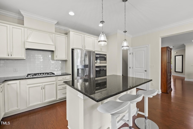 610 Chronicle Dr, Cary, NC 27513 - kitchen with appliances with stainless steel finishes, dark wood-style flooring, backsplash, crown molding, and a breakfast bar area