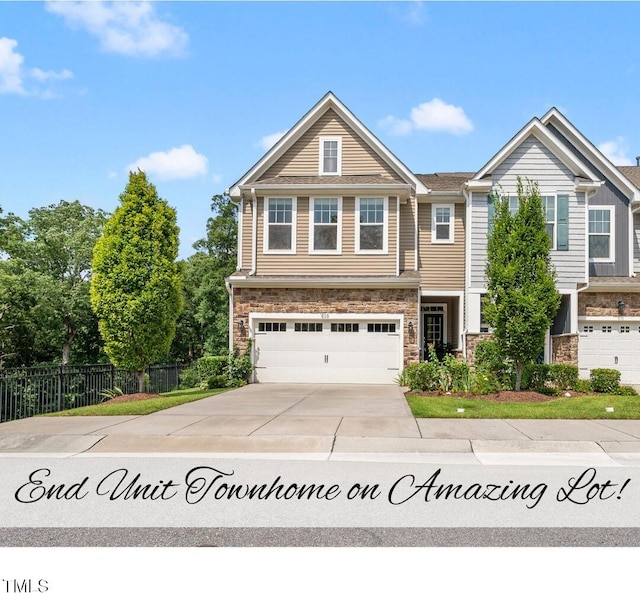 610 Chronicle Dr, Cary, NC 27513 - view of front of property featuring a garage, stone siding, and driveway