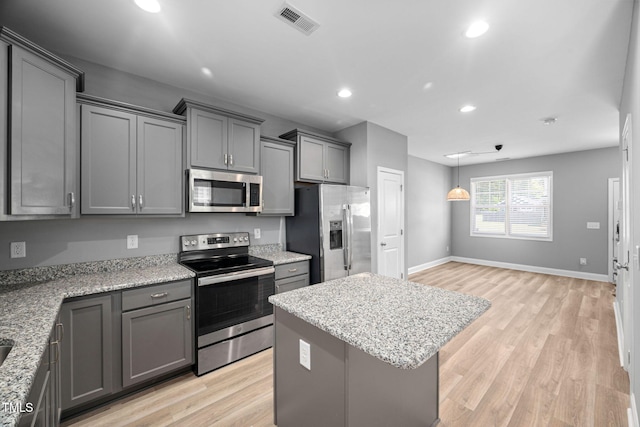 147 Sunfish St, Smithfield, NC 27577 - kitchen with appliances with stainless steel finishes, recessed lighting, light wood finished floors, a center island, and gray cabinetry