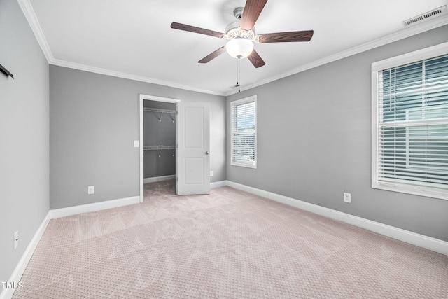 147 Sunfish St, Smithfield, NC 27577 - unfurnished bedroom with carpet flooring, ornamental molding, a closet, a walk in closet, and a ceiling fan