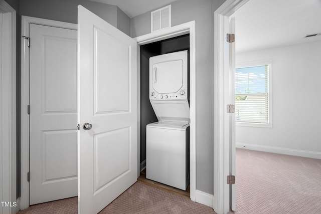 147 Sunfish St, Smithfield, NC 27577 - washroom with stacked washing machine and dryer and carpet