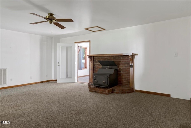 140 Maryland Dr, Manson, NC 27553 - unfurnished living room featuring a wood stove, carpet floors, a ceiling fan, and attic access