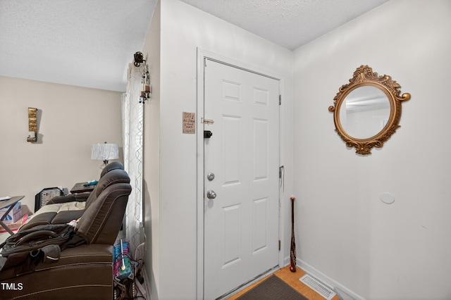 308 E Gilbreath St, Graham, NC 27253 - foyer with a textured ceiling and baseboards