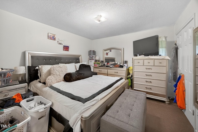 308 E Gilbreath St, Graham, NC 27253 - bedroom with dark colored carpet and a textured ceiling