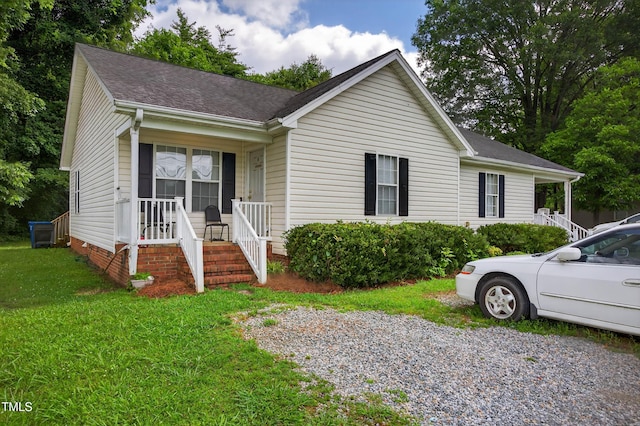 308 E Gilbreath St, Graham, NC 27253 - ranch-style house featuring covered porch, a front lawn, and a shingled roof