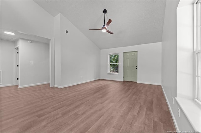 12741 Birchwood Cir, Laurinburg, NC 28352 - unfurnished living room with a ceiling fan, light wood-type flooring, a textured ceiling, and high vaulted ceiling