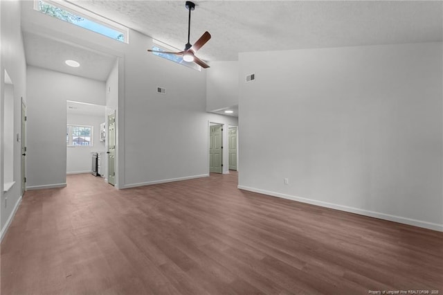 12741 Birchwood Cir, Laurinburg, NC 28352 - unfurnished living room featuring a ceiling fan, wood finished floors, high vaulted ceiling, and a textured ceiling