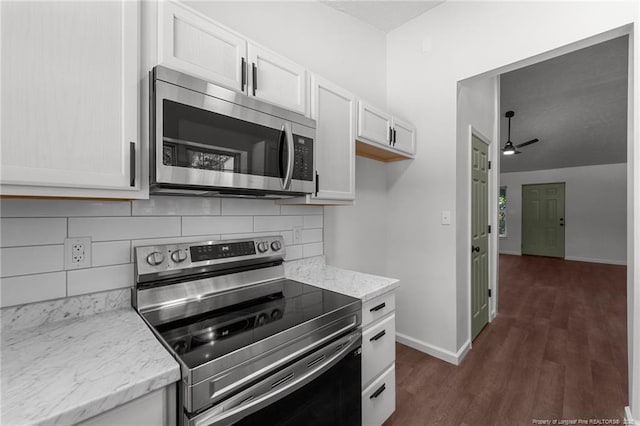 12741 Birchwood Cir, Laurinburg, NC 28352 - kitchen with appliances with stainless steel finishes, decorative backsplash, dark wood finished floors, light stone counters, and a ceiling fan