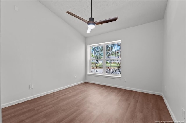 12741 Birchwood Cir, Laurinburg, NC 28352 - empty room featuring wood finished floors, vaulted ceiling, a ceiling fan, and a textured ceiling
