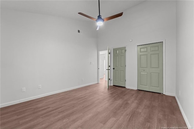 12741 Birchwood Cir, Laurinburg, NC 28352 - unfurnished bedroom featuring wood finished floors, a high ceiling, and ceiling fan