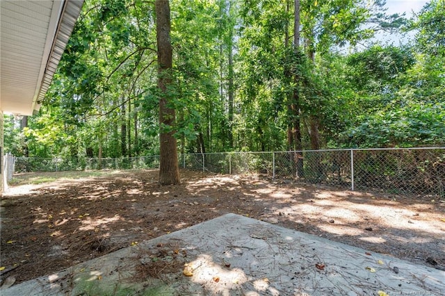 12741 Birchwood Cir, Laurinburg, NC 28352 - fenced backyard featuring a patio area and a forest view