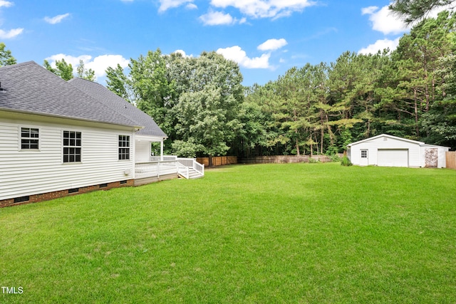 2430 Josephine Rd, Garner, NC 27529 - view of yard featuring a detached garage, an outdoor structure, and a wooden deck