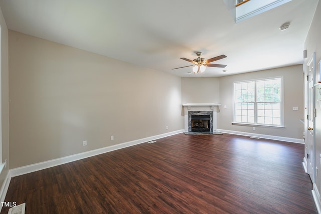 2430 Josephine Rd, Garner, NC 27529 - unfurnished living room with dark wood-type flooring, a ceiling fan, and a high end fireplace