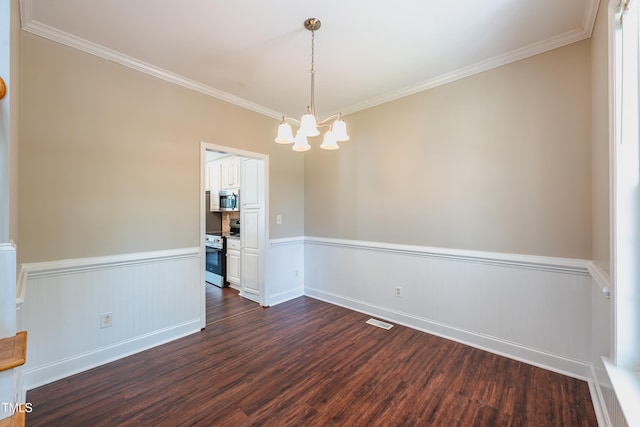 2430 Josephine Rd, Garner, NC 27529 - spare room with a chandelier, a wainscoted wall, dark wood-type flooring, and ornamental molding
