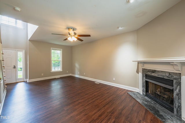 2430 Josephine Rd, Garner, NC 27529 - unfurnished living room featuring a high end fireplace, a ceiling fan, and dark wood-type flooring