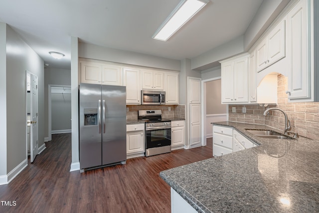 2430 Josephine Rd, Garner, NC 27529 - kitchen featuring appliances with stainless steel finishes, tasteful backsplash, white cabinetry, and dark wood-style flooring