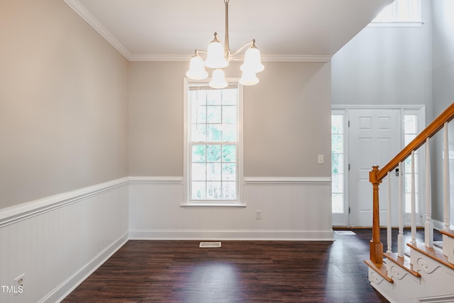 2430 Josephine Rd, Garner, NC 27529 - foyer entrance featuring a chandelier, a wainscoted wall, stairs, wood finished floors, and ornamental molding