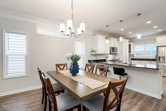 1125 Russet Ln, Apex, NC 27523 - dining area featuring ornamental molding, dark wood finished floors, a chandelier, and recessed lighting