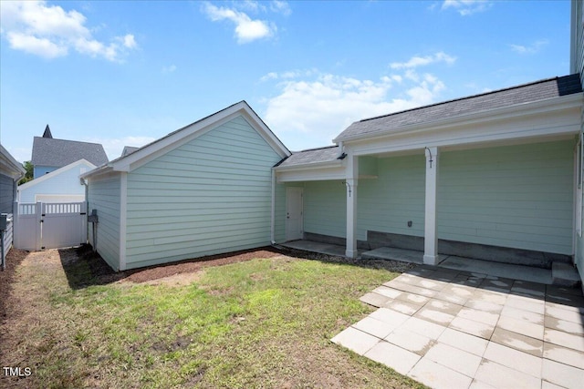 1125 Russet Ln, Apex, NC 27523 - back of property featuring a gate, a shingled roof, and a patio