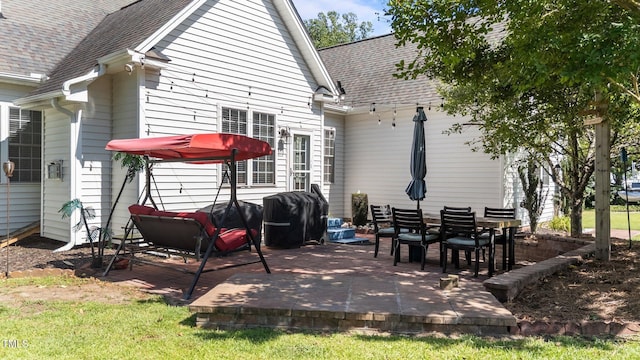 2813 Greenridge View Ln, Zebulon, NC 27597 - back of property featuring a shingled roof and a patio