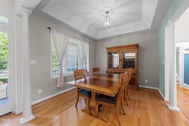 2813 Greenridge View Ln, Zebulon, NC 27597 - dining room featuring ornate columns, light wood-type flooring, and healthy amount of natural light