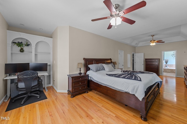 2813 Greenridge View Ln, Zebulon, NC 27597 - bedroom featuring light wood-style flooring, a desk, a tray ceiling, and ceiling fan