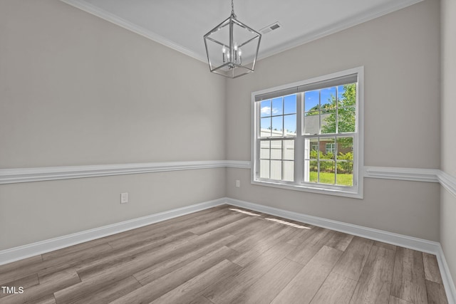 310 Oak Pointe Cir E, Lumberton, NC 28358 - empty room with a chandelier, wood finished floors, and ornamental molding