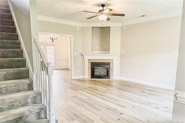 37 Annapolis Rd, Cameron, NC 28326 - unfurnished living room with wood finished floors, stairs, ornamental molding, a ceiling fan, and a fireplace