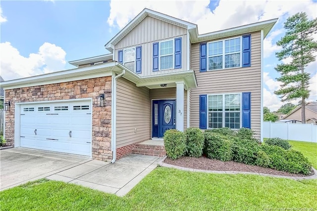 37 Annapolis Rd, Cameron, NC 28326 - view of front of house with stone siding, board and batten siding, an attached garage, and driveway
