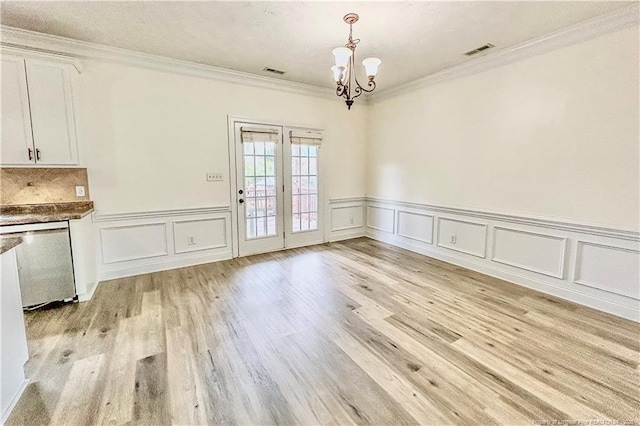 37 Annapolis Rd, Cameron, NC 28326 - unfurnished dining area with a chandelier, crown molding, wainscoting, light wood-style floors, and a decorative wall