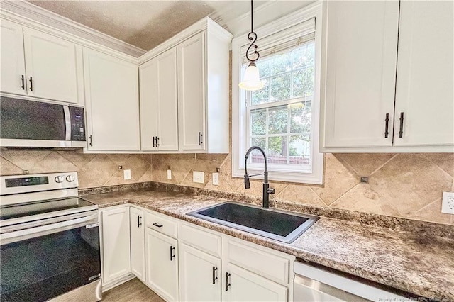 37 Annapolis Rd, Cameron, NC 28326 - kitchen with appliances with stainless steel finishes, white cabinets, pendant lighting, and decorative backsplash